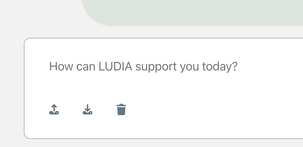 The chat box with the prompt “How can LUDIA support you today?” Below it are three buttons: download (down arrow) to save your chat, upload (up arrow) to open a saved chat, and a trash can to clear your chat and start over.
